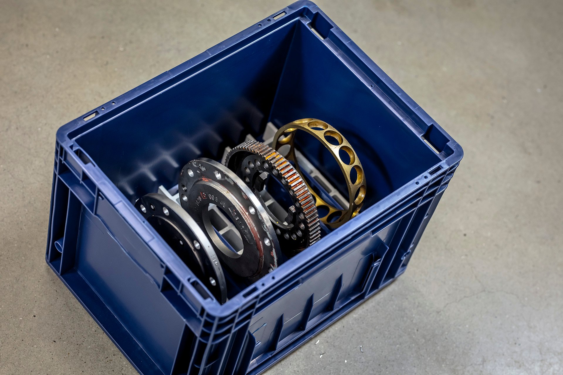 A 3D printed carrier tray in an industrial tote, used to keep heavy industry parts securely held during transit