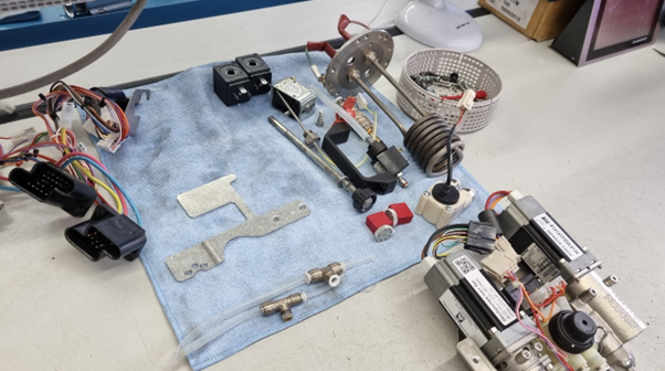 Performing maintenance on this DB coffee machine mechanism is made easier using assembly fixtures